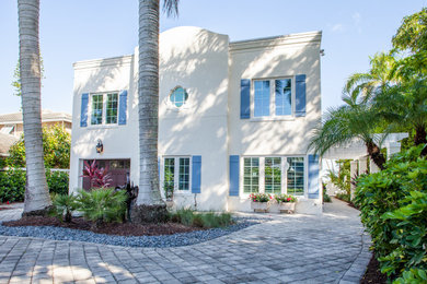 Inspiration for a mid-sized mediterranean white two-story stucco exterior home remodel in Miami