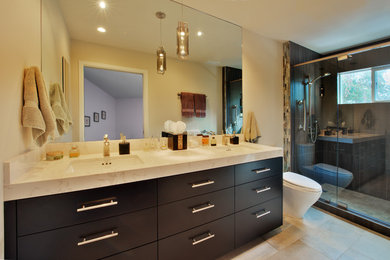 Inspiration for a mid-sized contemporary bathroom in San Francisco with an undermount sink, flat-panel cabinets, brown cabinets, engineered quartz benchtops, an alcove shower, a one-piece toilet, beige tile, porcelain tile, beige walls and porcelain floors.