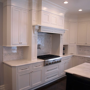 Large traditional kitchen pantry photos - Large elegant u-shaped dark wood floor and brown floor kitchen pantry photo in Newark with a drop-in sink, beaded inset cabinets, white cabinets, beige backsplash, stainless steel appliances and an island