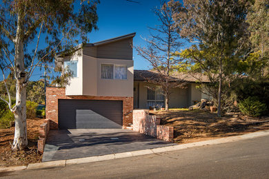This is an example of a contemporary two-storey exterior in Canberra - Queanbeyan with a shed roof.