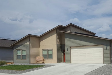Inspiration for a mid-sized contemporary brown one-story stucco house exterior remodel in Denver with a shingle roof