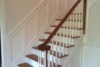 Inspiration for a mid-sized timeless wooden l-shaped wood railing staircase remodel in Chicago with painted risers