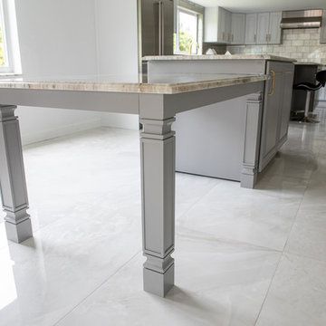 Transitional Kitchen Done in a 2 Tone Color With Integrated Dining Table