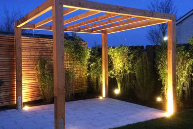 Inspiration for a large modern back patio in Other with fencing, natural stone paving and a pergola.