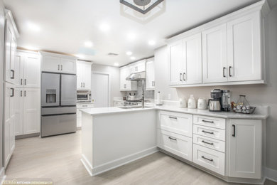 Example of a mid-sized transitional single-wall porcelain tile and beige floor eat-in kitchen design in Orlando with an undermount sink, shaker cabinets, white cabinets, quartz countertops, gray backsplash, ceramic backsplash, no island and white countertops