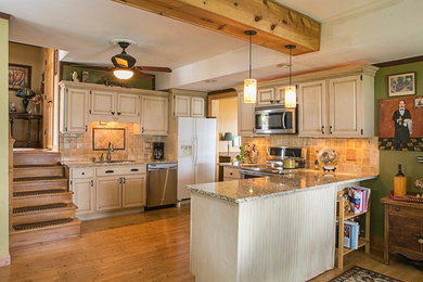 Inspiration for a mid-sized mediterranean u-shaped medium tone wood floor eat-in kitchen remodel in Milwaukee with a double-bowl sink, raised-panel cabinets, white cabinets, granite countertops, orange backsplash, porcelain backsplash, stainless steel appliances and a peninsula