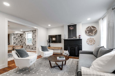 Inspiration for a contemporary medium tone wood floor and wallpaper living room remodel in Richmond with white walls and a wall-mounted tv