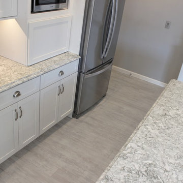 Alpha, IL White and Gray Kitchen with Hidden Laundry and Raised Dishwasher