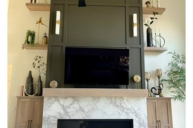Example of a transitional open concept laminate floor and beige floor living room design in Other with white walls, a standard fireplace, a stone fireplace and a wall-mounted tv