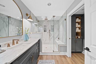 Mid-sized transitional master gray tile and porcelain tile porcelain tile, brown floor and single-sink bathroom photo in Other with recessed-panel cabinets, gray cabinets, a two-piece toilet, gray walls, an undermount sink, quartz countertops, a hinged shower door, gray countertops and a built-in vanity