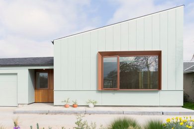 Example of a mid-sized trendy green one-story mixed siding and board and batten house exterior design in San Francisco with a shed roof, a shingle roof and a gray roof