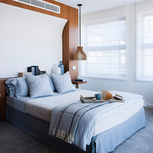 Inspiration for a large contemporary master bedroom in Sydney with white walls, carpet and blue floor.