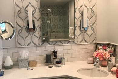 Example of a mid-sized transitional master white tile and stone tile porcelain tile and white floor doorless shower design in Chicago with shaker cabinets, white cabinets, a one-piece toilet, white walls, an undermount sink, quartz countertops and a hinged shower door