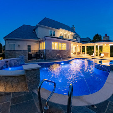 Naperville, IL freeform swimming pool with hot tub, large sunshelf, glass tile