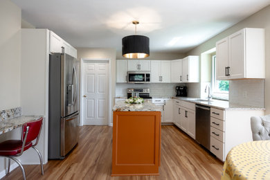 Eat-in kitchen - mid-sized transitional l-shaped eat-in kitchen idea in Cleveland with shaker cabinets, white cabinets and an island