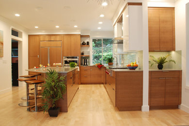 Inspiration for a large contemporary l-shaped kitchen in Seattle with flat-panel cabinets, light wood cabinets, green splashback, stainless steel appliances, light hardwood floors and with island.