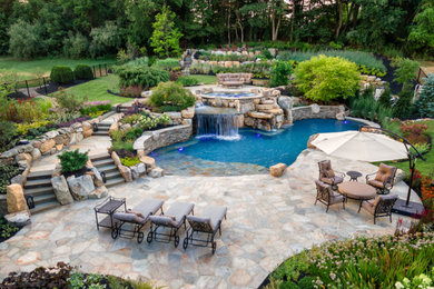 Pool landscaping - large rustic backyard stone and custom-shaped natural pool landscaping idea in New York