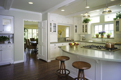 Design ideas for a traditional kitchen in Los Angeles with glass-front cabinets and subway tile splashback.