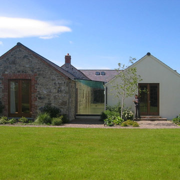Hilltop stone farm buildings converted and extended to form modern family home