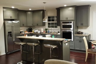 Mid-sized trendy l-shaped dark wood floor open concept kitchen photo in Birmingham with an undermount sink, shaker cabinets, gray cabinets, granite countertops, stainless steel appliances and an island