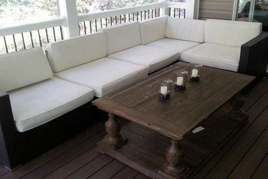Inspiration for a transitional backyard deck remodel in Baltimore with a roof extension