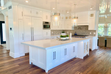 Inspiration for a large contemporary l-shaped dark wood floor, brown floor and shiplap ceiling open concept kitchen remodel in San Diego with a farmhouse sink, beaded inset cabinets, white cabinets, quartz countertops, brown backsplash, mosaic tile backsplash, stainless steel appliances, an island and white countertops