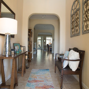 Small southwest travertine floor and yellow floor entryway photo in San Francisco with yellow walls and a white front door