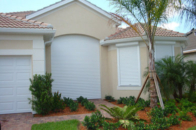 Inspiration for a mid-sized transitional beige stucco house exterior remodel in Phoenix