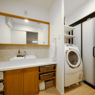 Design ideas for a modern utility room in Kyoto with composite countertops, bamboo flooring and a side by side washer and dryer.