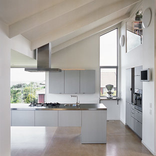 Contemporary kitchen pantry remodeling - Kitchen pantry - contemporary l-shaped concrete floor kitchen pantry idea in Wellington with a single-bowl sink, gray cabinets, stainless steel countertops, stainless steel appliances and an island