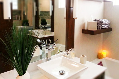 Inspiration for a mid-sized contemporary master pebble tile bathroom remodel in Miami with shaker cabinets, dark wood cabinets, beige walls, a vessel sink and quartz countertops