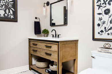 Inspiration for a mid-sized transitional gray tile concrete floor and multicolored floor bathroom remodel in Detroit with open cabinets, distressed cabinets, a one-piece toilet, an undermount sink, quartz countertops and white countertops