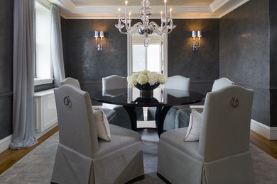 Inspiration for a mid-sized transitional medium tone wood floor enclosed dining room remodel in New York with gray walls and no fireplace