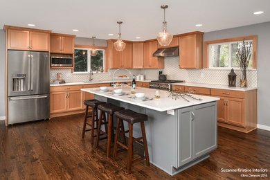 Example of a large transitional l-shaped medium tone wood floor and brown floor eat-in kitchen design in Seattle with an undermount sink, shaker cabinets, gray cabinets, quartz countertops, white backsplash, ceramic backsplash, stainless steel appliances, an island and white countertops