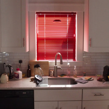 Window treatments in a white living room and kitchen