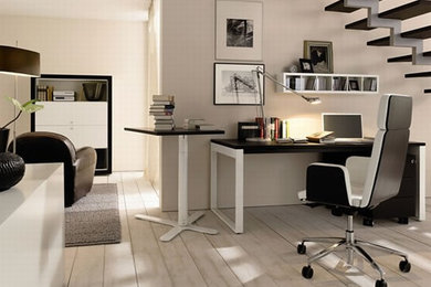 Study room - mid-sized modern freestanding desk light wood floor study room idea in Los Angeles with beige walls