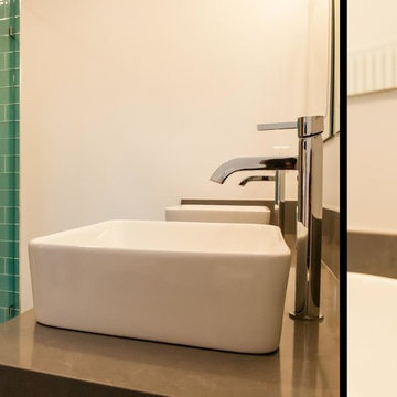 Close Up - Sink Faucet, and the Shower in Background