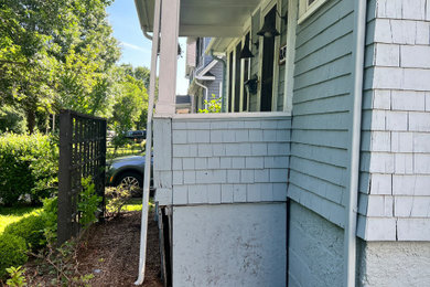 Inspiration for a small country wood railing front porch remodel in Boston with a roof extension