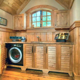 Inspiration for a classic utility room in San Francisco with louvered cabinets, medium wood cabinets, beige walls and medium hardwood flooring.