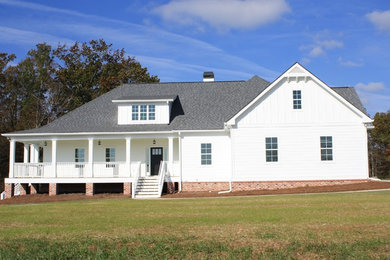 Example of a farmhouse white three-story mixed siding house exterior design in Atlanta with a hip roof and a shingle roof
