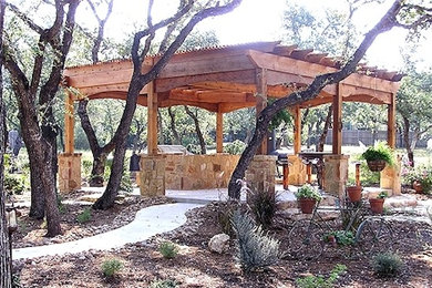Inspiration for a large timeless backyard concrete patio remodel in Austin with a pergola
