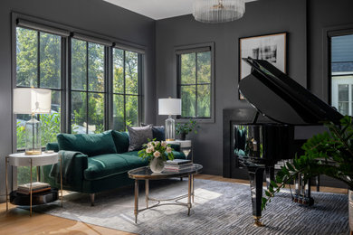 Inspiration for a mid-sized transitional enclosed light wood floor living room remodel in DC Metro with a music area, black walls, a standard fireplace, a stone fireplace and no tv