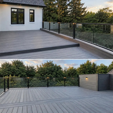 The composite deck and glass railing looking out over mature trees, King City