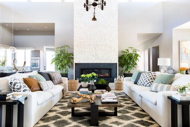 This is an example of a large contemporary formal open concept living room in Phoenix with white walls, light hardwood floors, a ribbon fireplace, a tile fireplace surround, no tv and beige floor.
