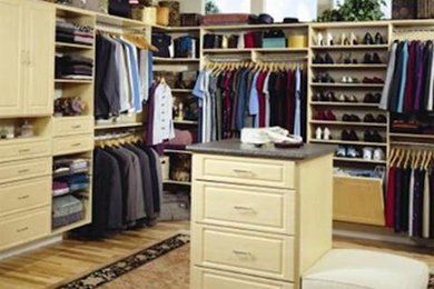 Inspiration for a mid-sized men's carpeted walk-in closet remodel in Boston with light wood cabinets