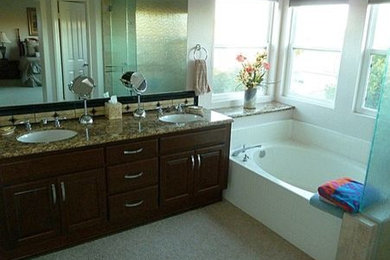 Inspiration for a large timeless multicolored tile and ceramic tile ceramic tile bathroom remodel in San Diego with an undermount sink, raised-panel cabinets, dark wood cabinets, granite countertops, a one-piece toilet and white walls
