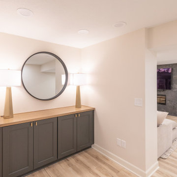 Warm & Inviting Basement Retreat with Custom Bar + Entertainment Center