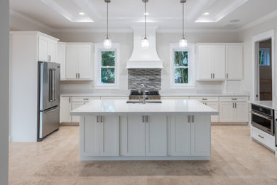 Design ideas for a large transitional open plan kitchen in Miami with shaker cabinets, white cabinets, grey splashback, stainless steel appliances, with island, beige floor, white benchtop and recessed.