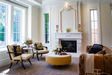 Example of a transitional living room design in Vancouver with white walls and a standard fireplace