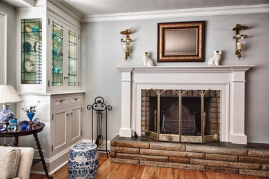 Inspiration for a large timeless formal and enclosed dark wood floor living room remodel in Toronto with gray walls, a standard fireplace, a plaster fireplace and a media wall
